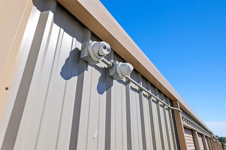 Security cameras mounted on the exterior of a storage building.