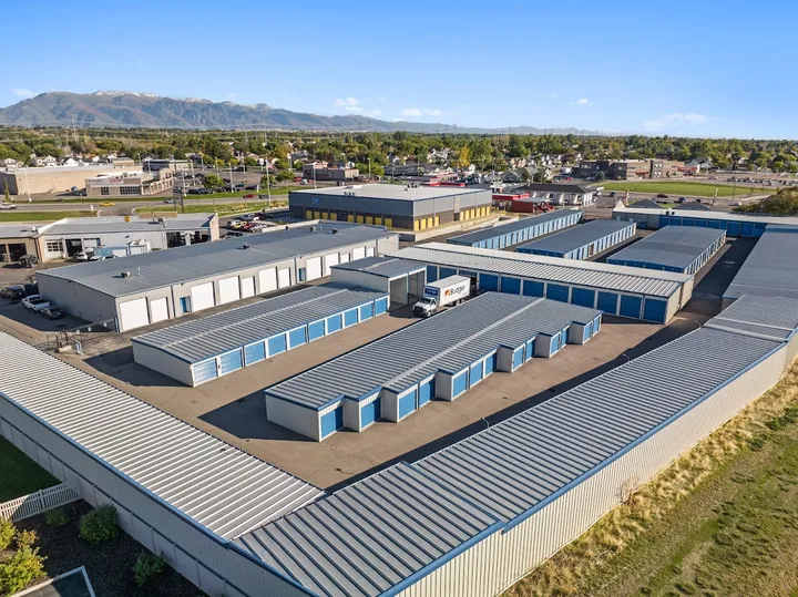 Aerial view of multiple storage unit buildings with a moving truck.