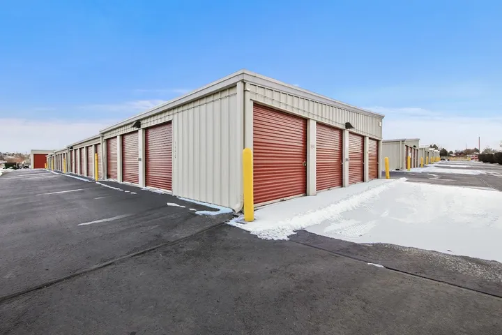 Outdoor storage units with snow along the access lanes.