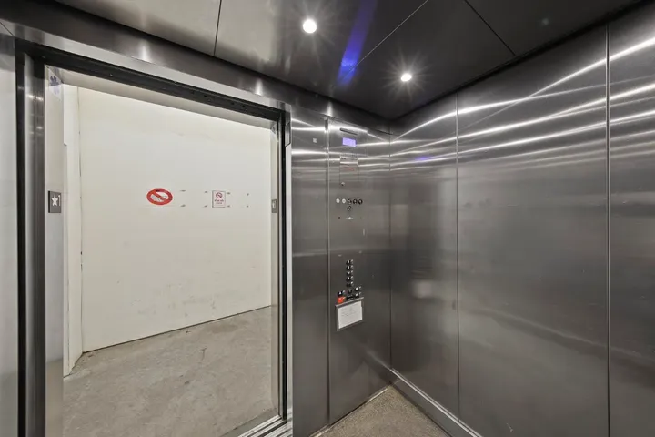 Interior of a modern stainless steel elevator.