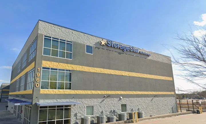 Side exterior view of the multi-story storage building with brand signage.