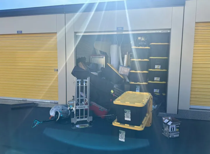 Storage unit being loaded with boxes and a hand truck.