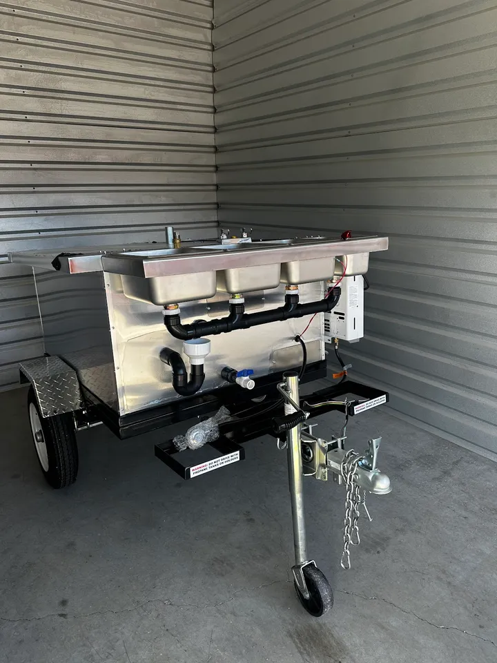 Portable sink unit inside an empty storage unit.