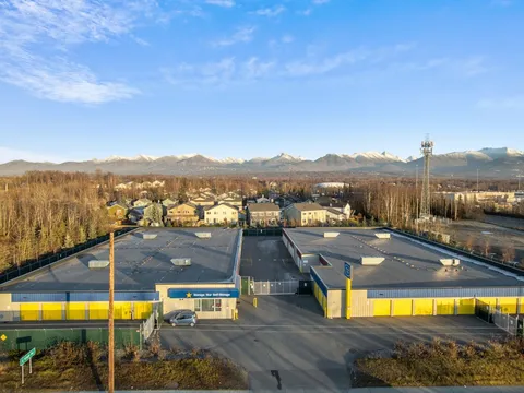 Aerial overview of storage facility buildings and surrounding residential area.