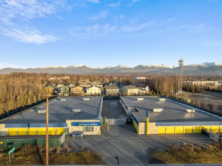Aerial overview of storage facility buildings and surrounding residential area.