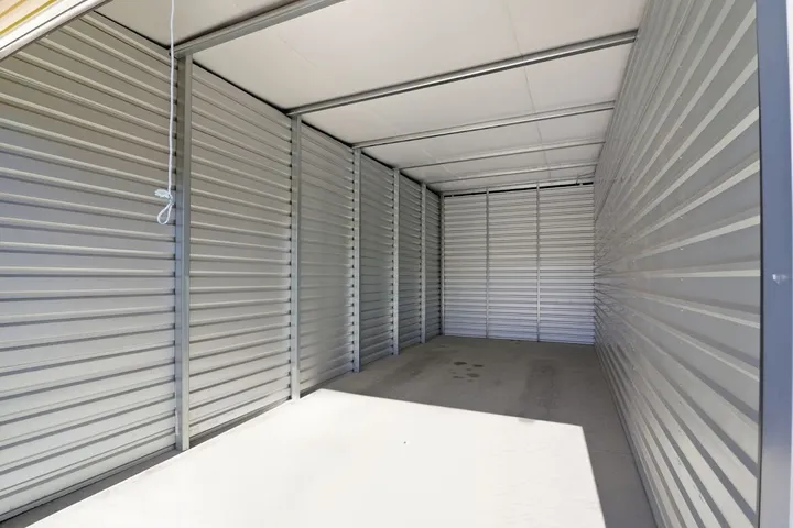 Empty storage unit interior with bright lighting.
