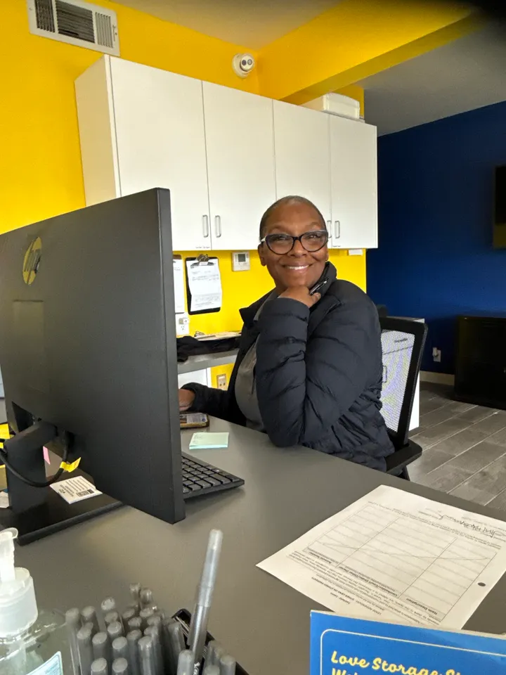 Friendly team member at the office reception desk.