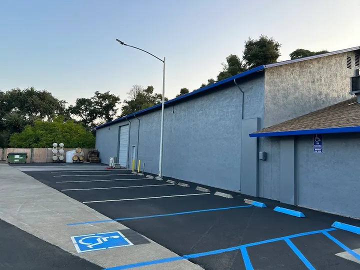 Side exterior of the storage building with marked parking spaces