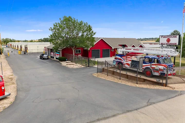 An aerial view of the storage facility entrance, office, and American-flag fire truck.