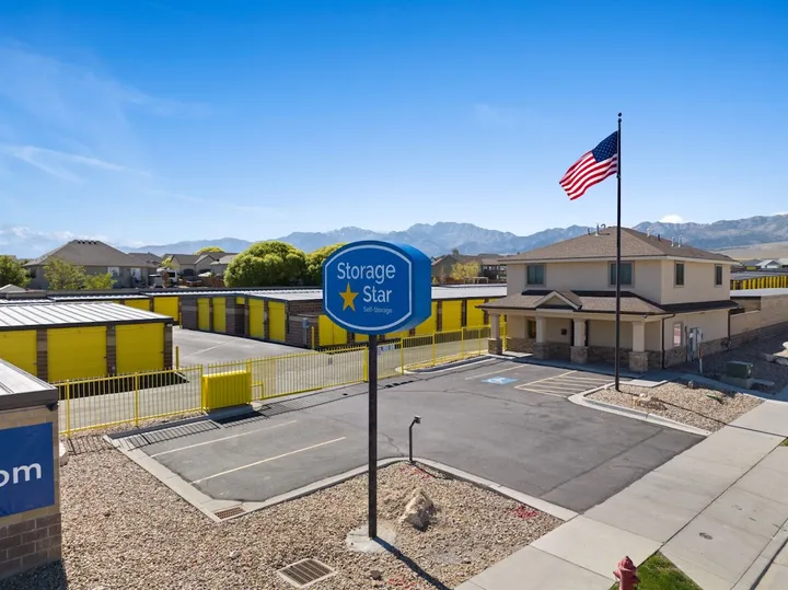 Storage Star Self Storage facility entrance with sign and American flag.