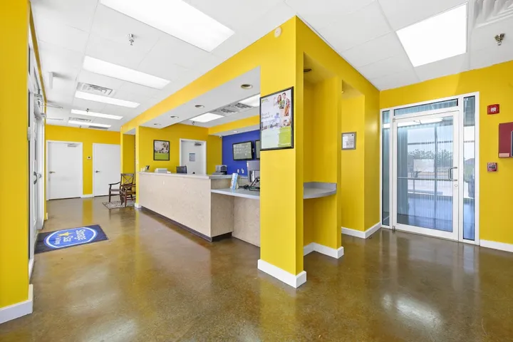 Bright yellow self-storage office interior with front desk.