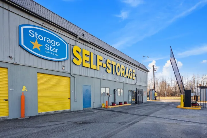 Exterior of building with Storage Star logo and large SELF-STORAGE sign on wall.