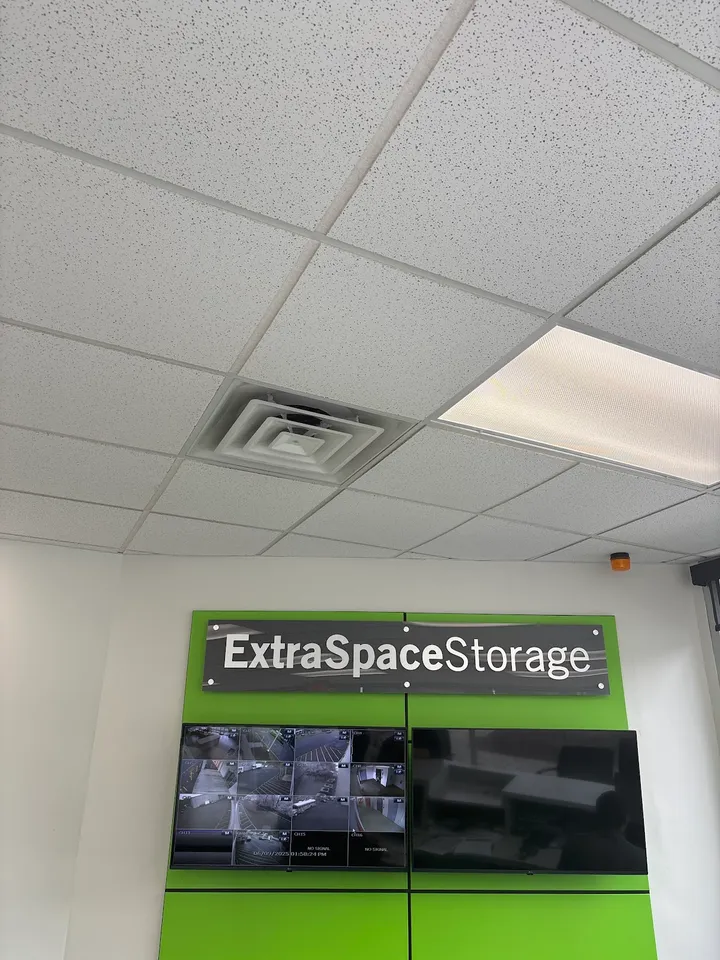Extra Space Storage logo and security camera monitors in the office