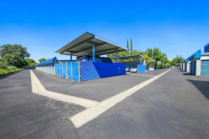 Outdoor RV and boat parking spaces under a metal canopy.