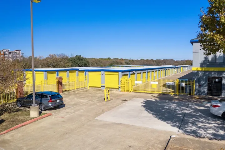 Exterior view of storage facility with gated entrance and drive-up units.