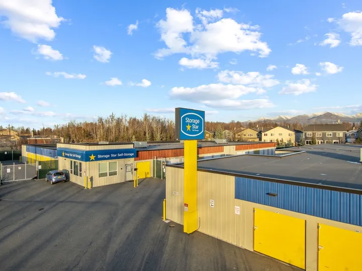 Aerial view of storage facility with drive-up units and main sign.