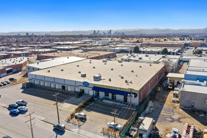 Aerial view of self storage facility with city skyline in distance