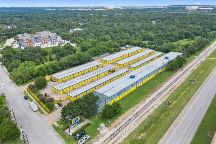 Aerial view of self-storage facility with multiple buildings and roads.