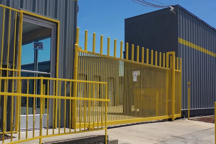 Yellow security gate and entrance to a storage facility.