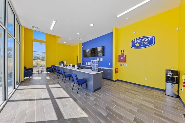 Bright yellow office interior with a long counter and seating.