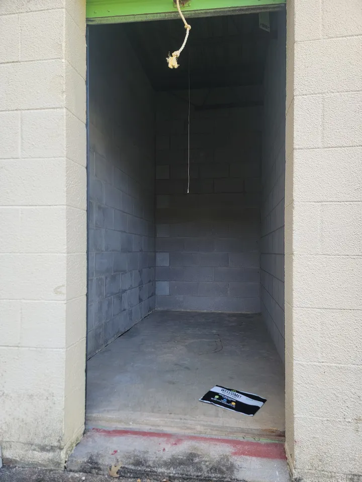 Empty storage unit interior with concrete block walls.
