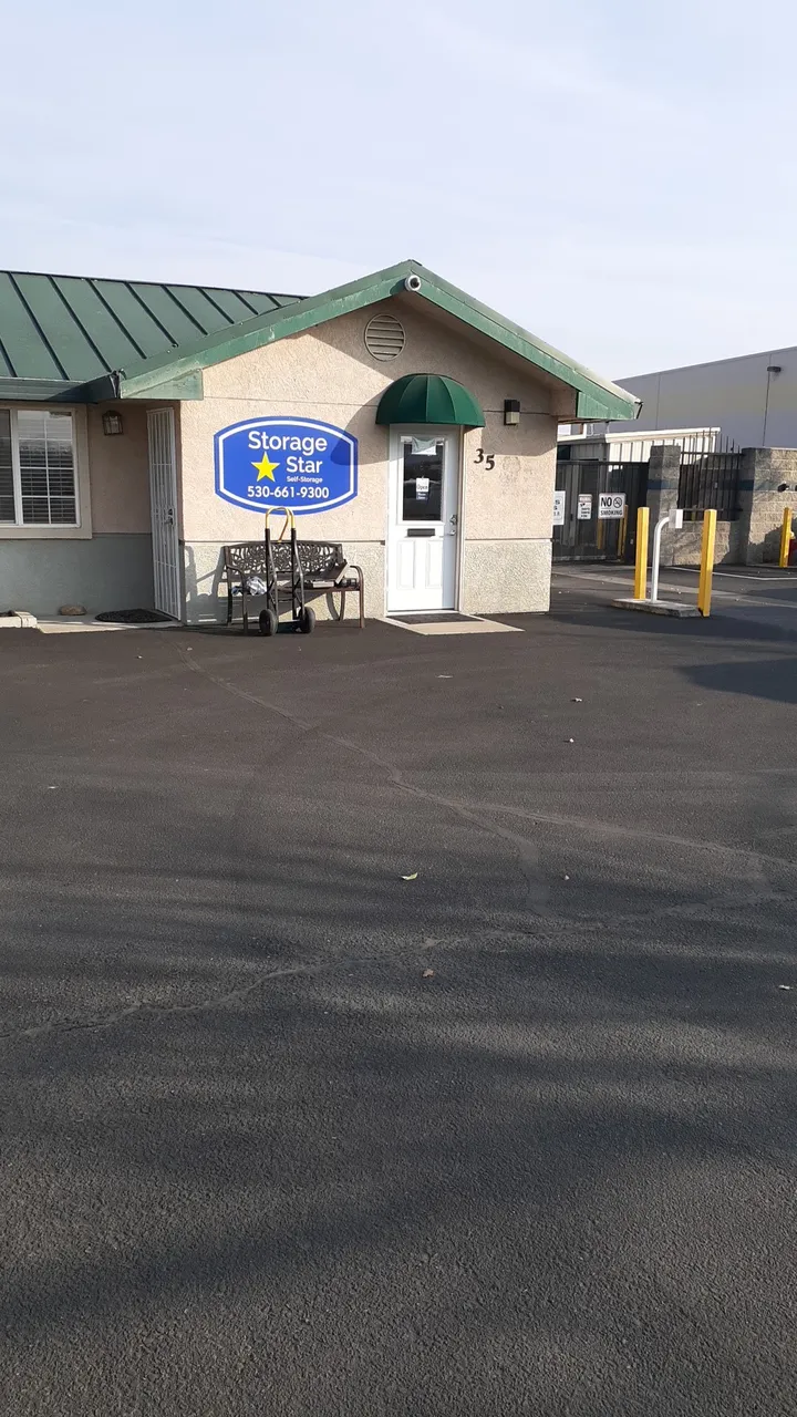Front view of the office building with a Storage Star sign and entrance gate.