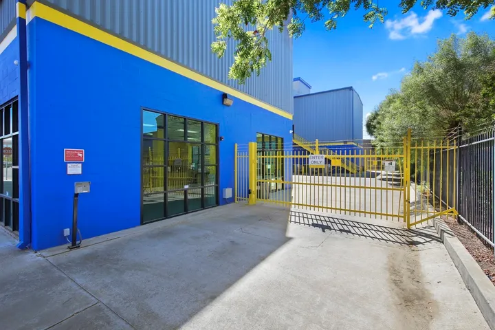 Exterior of facility with yellow security gate.