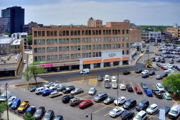 Wide angle overhead shot of facility exterior and parking lot.