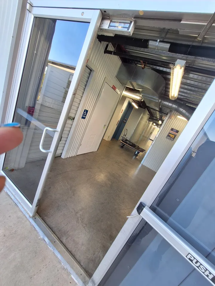 View through glass door into storage unit hallway.
