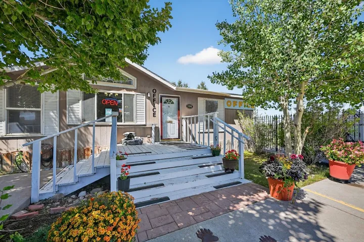 Exterior of the Storage Star leasing office on Skyline Road, featuring white stairs, a front porch, and potted flowers