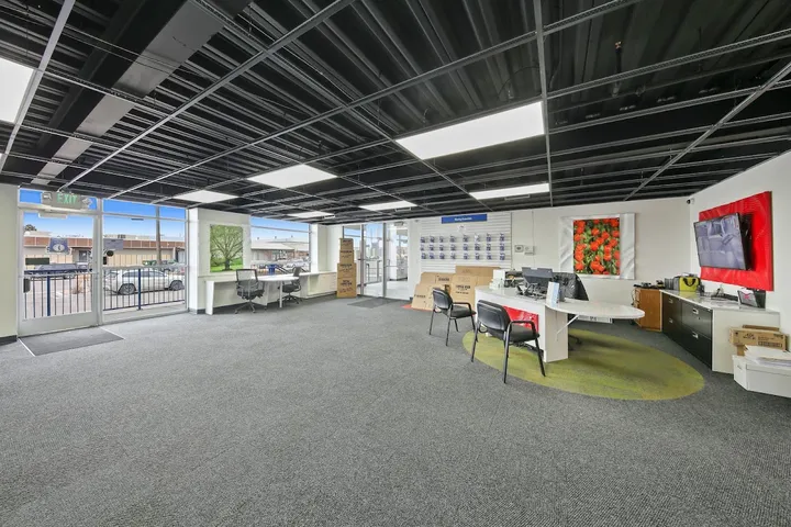 Storage facility office with desks, seating, and packing supplies