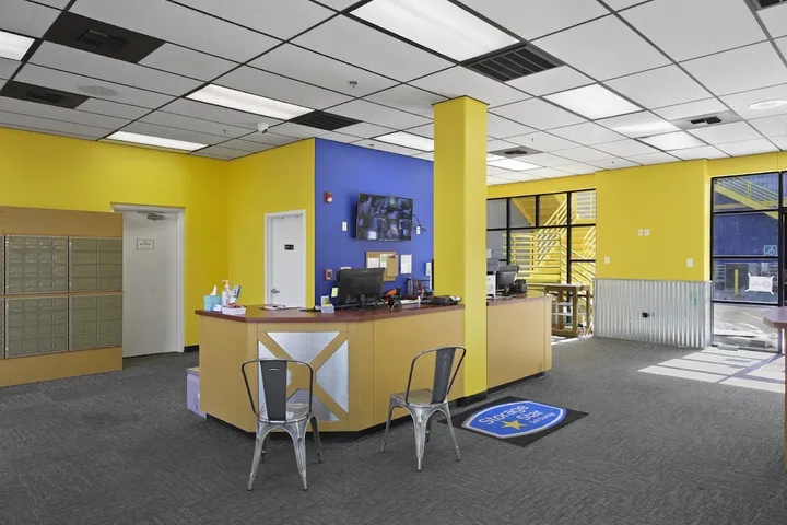 Interior office and reception area with yellow and blue walls.