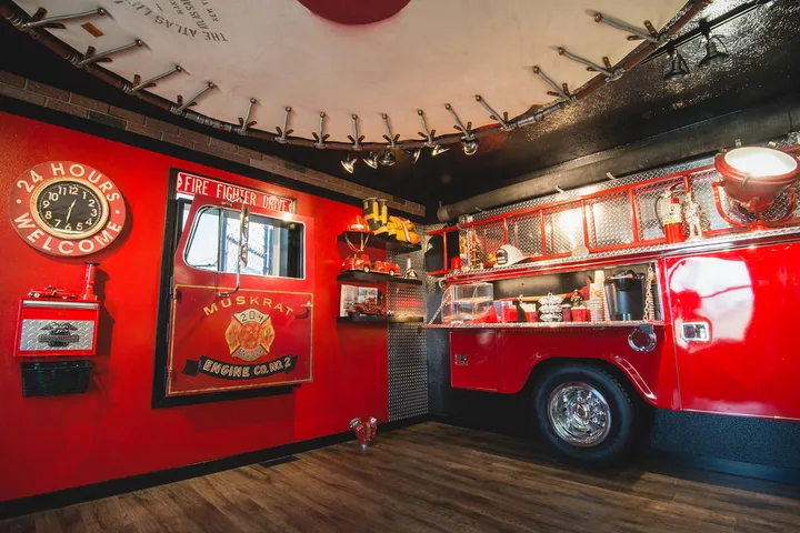 Office interior themed like a fire station with a red fire truck facade.