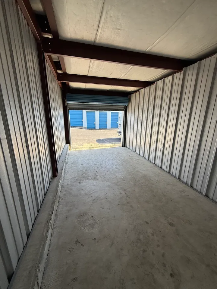 View from inside a storage unit looking out at other units