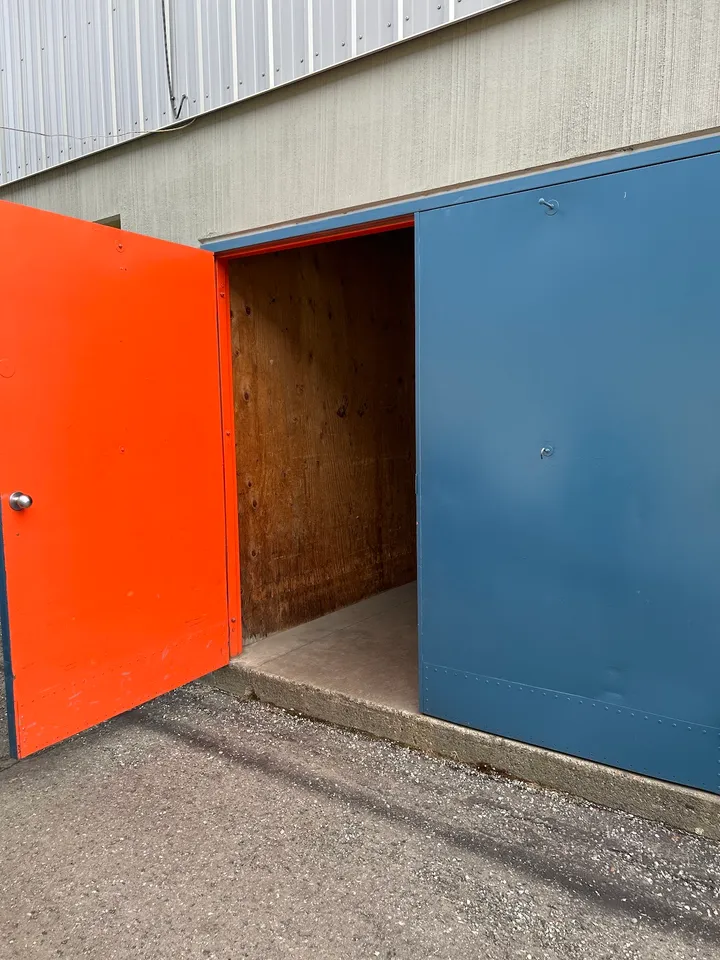 Open storage unit door revealing the interior of the unit.