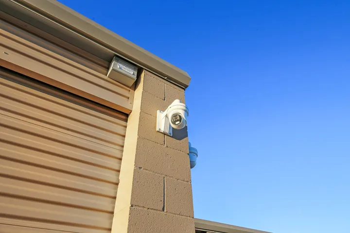 Security camera mounted on the side of a storage building.