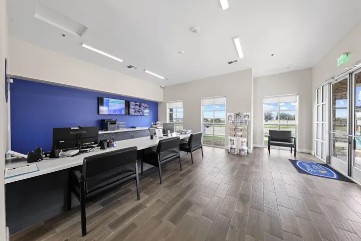 Customer service office with counter, chairs, and packing supplies display.
