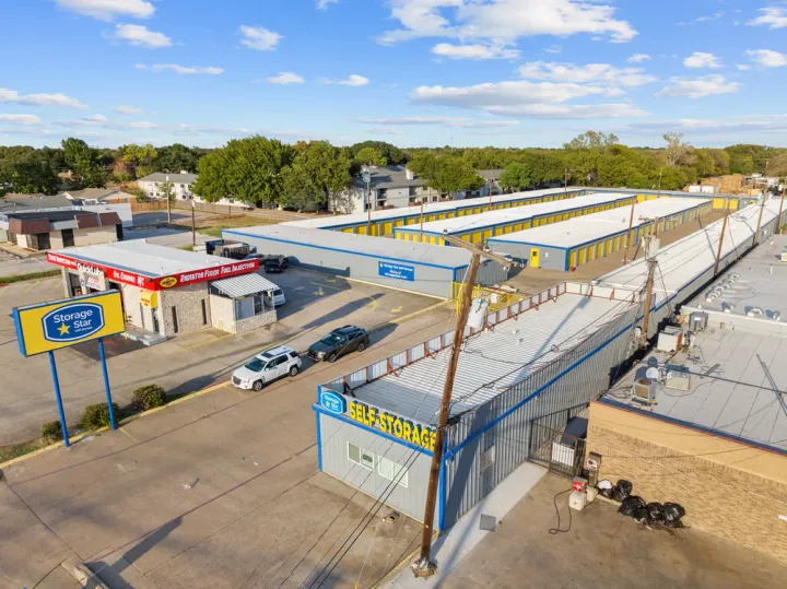 Aerial view of drive-up self-storage buildings at Storage Star in Irving, TX, with yellow roll-up doors and gray metal roofs